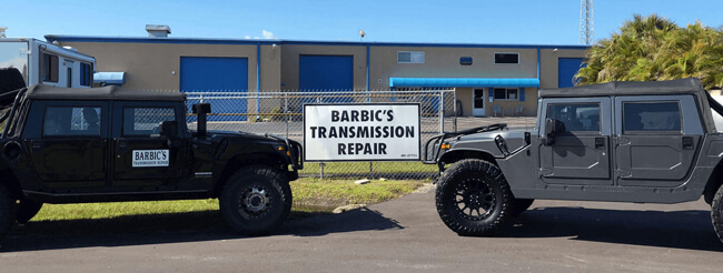 Barbic's Transmission Repair sign and Hummers
